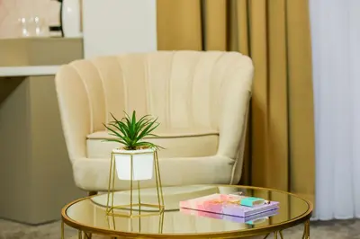 a living room with a chair and a table with a plant at Hotel City View in Prnjavor