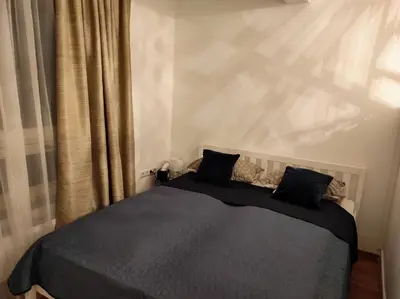 a bedroom with a bed with two black pillows at Apartman HANA in Travnik