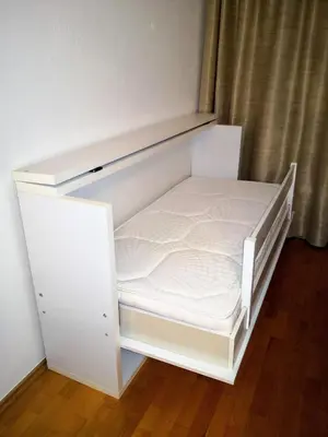 an empty white bed in a room with a curtain at Apartman HANA in Travnik