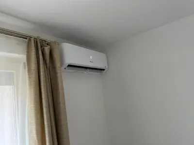 a wall mounted air conditioner in a room with a curtain at Apartman HANA in Travnik