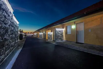 a row of buildings on a street at night at Motel Atos Bungalovi in Nova Topola
