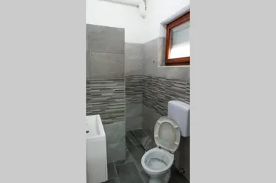 a bathroom with a toilet and a window at apartment HOME in Bihać