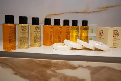 a shelf with a bunch of bottles of hair products at Hotel Grand in Banja Luka