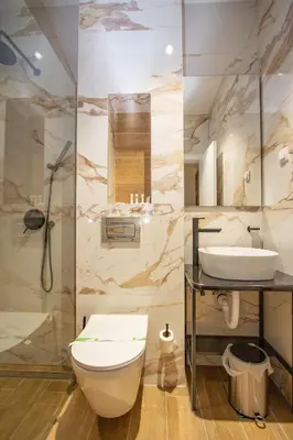 a bathroom with a toilet and a sink at Hotel Grand in Banja Luka