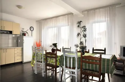 a kitchen and dining room with a table and chairs at Hostel Room in Banja Luka