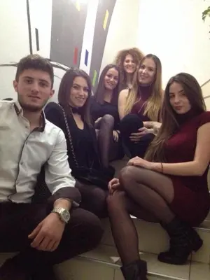 a group of young women sitting on a bench at Hostel Room in Banja Luka