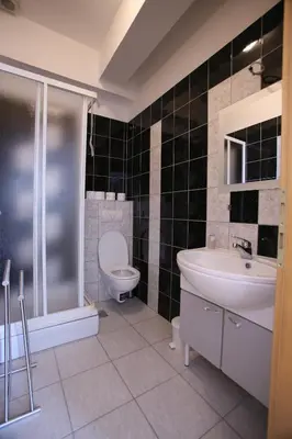 a bathroom with a toilet and a sink and a shower at Motel Maks in Kiseljak