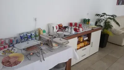 a kitchen with two sinks and a counter with food at Motel Maks in Kiseljak