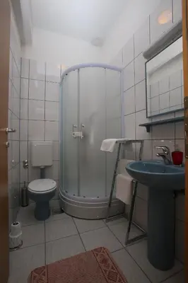 a bathroom with a shower and a toilet and a sink at Motel Maks in Kiseljak