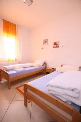 a room with two beds and a window at Motel Maks in Kiseljak