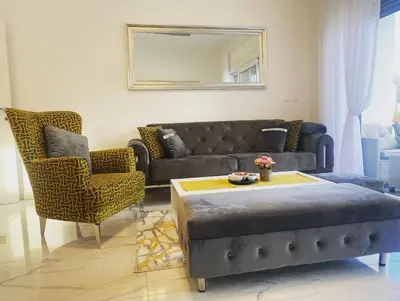 a living room with a couch and a table and chairs at River Luxury House in Bihać