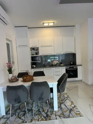 a kitchen with a white table and chairs at River Luxury House in Bihać