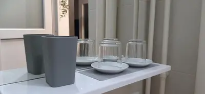 a counter with three glass jars and bowls on it at Apartman Tvrdjava in Banja Luka