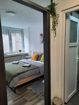 a bedroom with a bed with orange pillows at Apartman Tvrdjava in Banja Luka