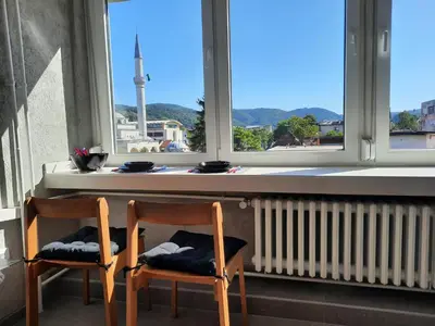 two chairs sitting in front of a window with a view at Apartman Tvrdjava in Banja Luka
