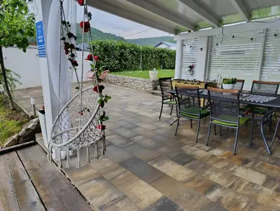 a patio with a table and chairs on it at Una Luxury Home in Bihać