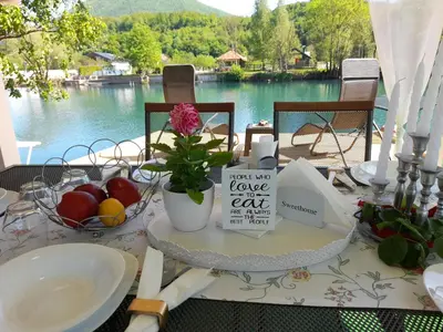 a table with a bowl of fruit and a sign that reads take no leave eat at Una Luxury Home in Bihać