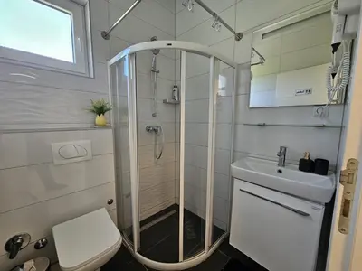 a bathroom with a shower and a toilet and a sink at Una Luxury Home in Bihać