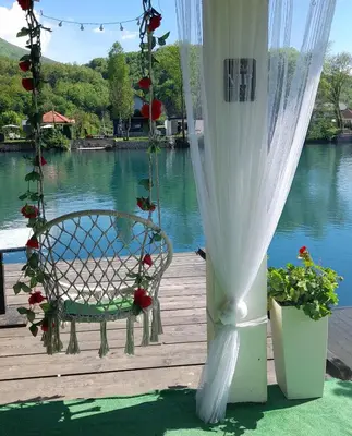a swing on a deck with a view of the water at Una Luxury Home in Bihać