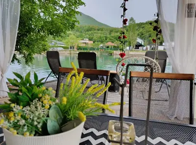 a patio with plants and a view of the water at Una Luxury Home in Bihać