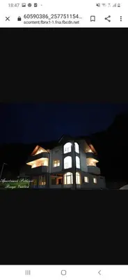 a building with lights on top of it at night at APARTMANI PETKOVIC in Teslić