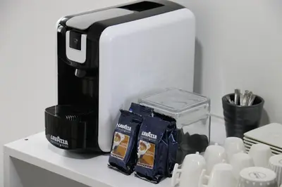 a toaster sitting on top of a counter with cups at Royal City Apartments in Jajce