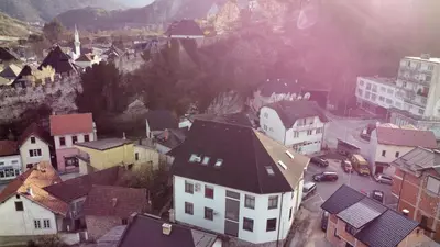 an aerial view of a town with buildings and a mountain at Royal City Apartments in Jajce