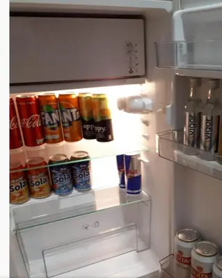 an open refrigerator filled with lots of drinks at Apartman 053 in Doboj