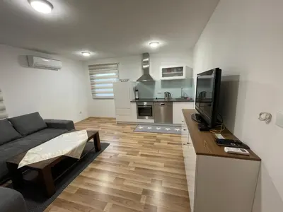 a living room with a couch and a flat screen tv at Oaza in Jelah
