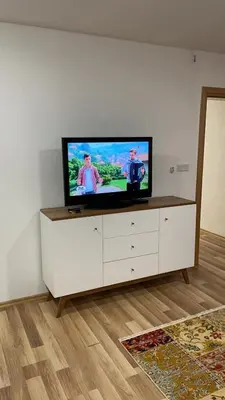a flat screen tv sitting on top of a white cabinet at Oaza in Jelah