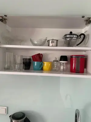 a shelf with bowls and other kitchen utensils at Oaza in Jelah