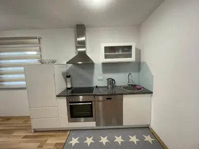 a small kitchen with a sink and a stove at Oaza in Jelah