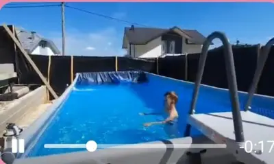 a woman is in a swimming pool in a house at Vila Anđelija in Velika Kladuša