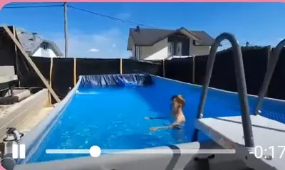 a woman is in a swimming pool at Vila Anđelija in Velika Kladuša