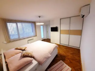 a bedroom with a bed and a television in it at Vila Galerija in Banja Luka