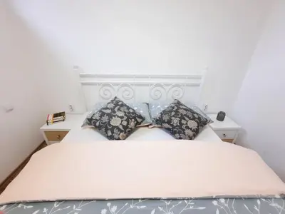 a bedroom with a white bed with two pillows at Vila Galerija in Banja Luka
