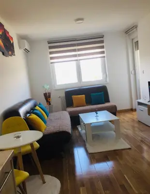 a living room with a couch and a table at Apartman Tami in Doboj