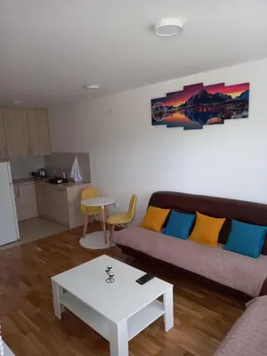 a living room with a couch and a table at Apartman Tami in Doboj