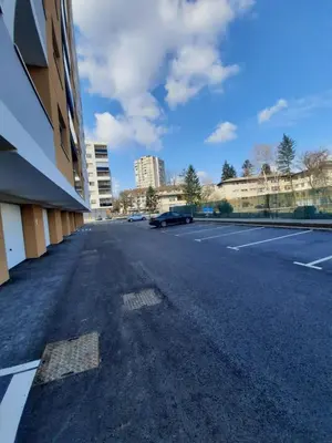 an empty parking lot next to a building at Apartman Tami in Doboj