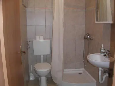 a small bathroom with a toilet and a sink at Apartments Marevic in Kupres