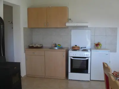 a kitchen with a white stove and a white refrigerator at Apartments Marevic in Kupres