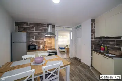a kitchen and dining room with a table and chairs at Pansion Beg in Tuzla