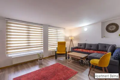 a living room with a couch and a chair at Pansion Beg in Tuzla