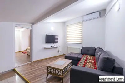 a living room with a couch and a tv at Pansion Beg in Tuzla