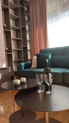 a living room with a green couch and a table at Apartman Green Lux in Banja Luka