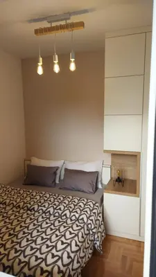 a bedroom with a bed with a black and white comforter at Apartman Green Lux in Banja Luka