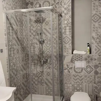 a shower stall in a bathroom with a toilet at Apartman Green Lux in Banja Luka