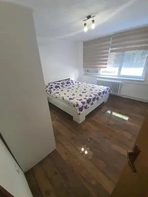 a bedroom with a bed in the corner of a room at Apartment City Centar in Banja Luka