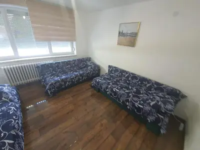 a living room with two couches and a window at Apartment City Centar in Banja Luka