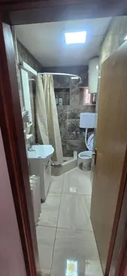 a bathroom with two toilets and a sink and a shower at Apartment City Centar in Banja Luka